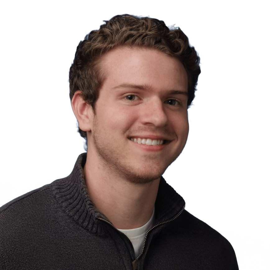 Headshot of Dr. Dylan Waugh wearing a white shirt top with brown jacket in a white background.